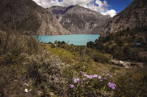 Shey Phoksundo Lake with turquoise blue water surrounded by rugged Himalayan mountains in Dolpo, Nepal